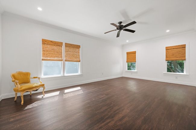 Unfurnished room featuring dark wood finished floors, recessed lighting, a ceiling fan, and ornamental molding | Image 24