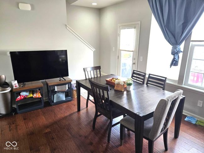 dining space with wood finished floors and baseboards | Image 7