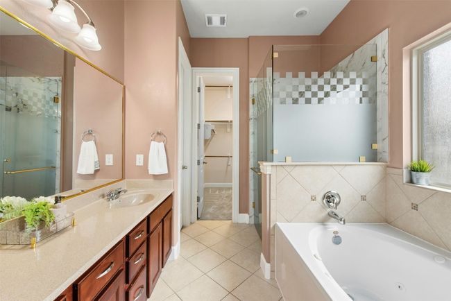 Dual vanity separate walk in shower and soaking tub. Large walk in closet. | Image 13