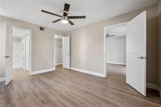 Unfurnished bedroom featuring ceiling fan, a closet, light hardwood / wood-style floors, and a spacious closet | Image 5