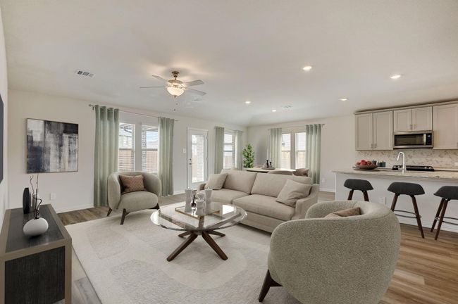 Living room with recessed lighting, healthy amount of natural light, light wood finished floors, and a ceiling fan | Image 4
