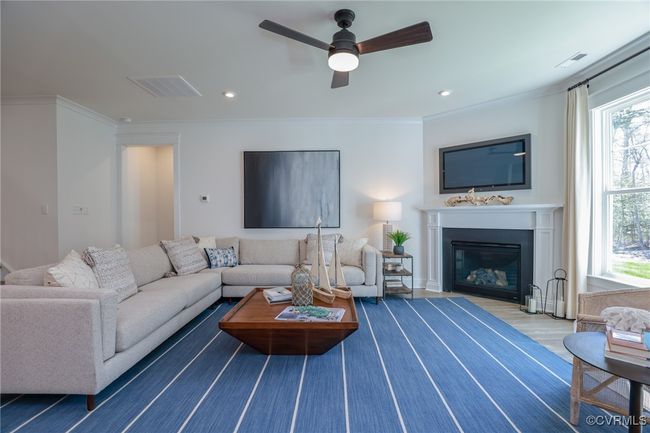 Bright and spacious family room with gas fireplace. | Image 10
