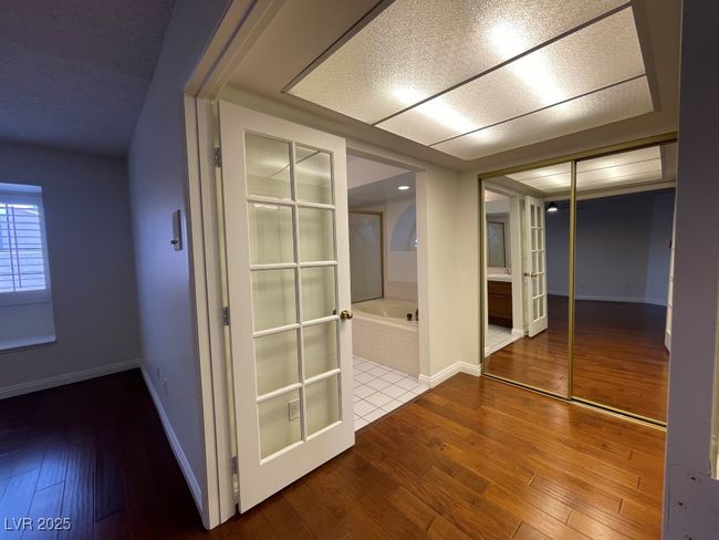 Hall with wood-type flooring and baseboards | Image 25