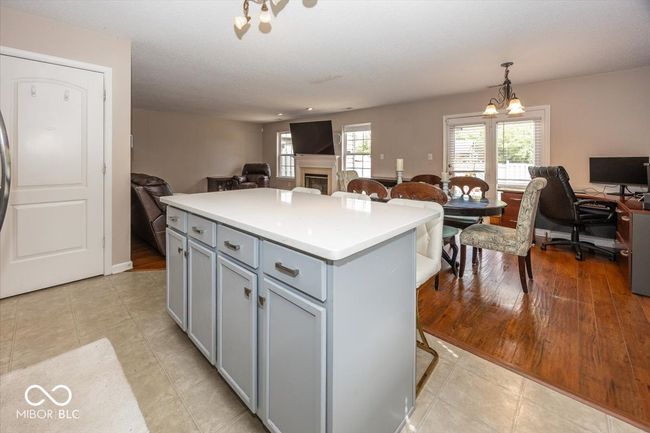kitchen featuring a center island, open floor plan, light countertops, and gray cabinets | Image 12