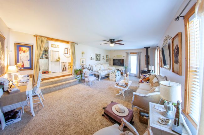 Carpeted living room featuring ceiling fan | Image 15