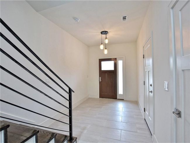 Entryway featuring stairway and light tile patterned floors | Image 4