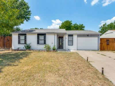 Single story home featuring a garage and a front lawn | Image 1