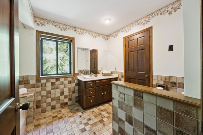 The bathroom that leads to the laundry through the door on the right. Jetted tub is on the left of this photo. | Image 20