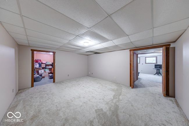 carpeted spare room featuring a paneled ceiling | Image 24