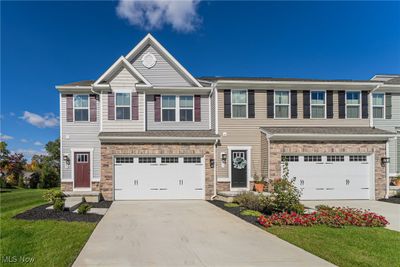 View of front facade with a front yard and a garage | Image 1