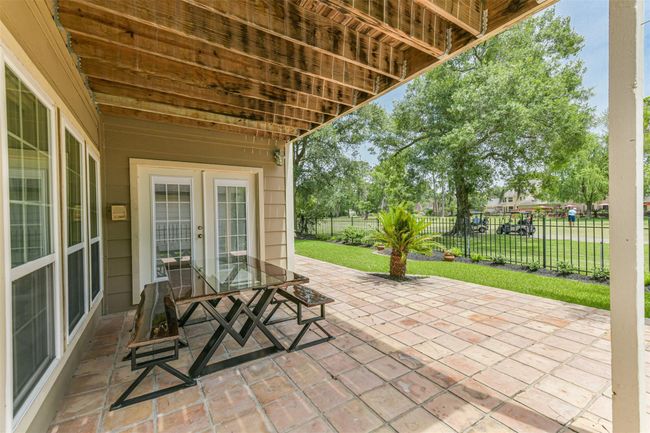 Doors from Family Room lead out to this charming covered back patio. Enjoy watching the action on the 3rd T-box! | Image 41