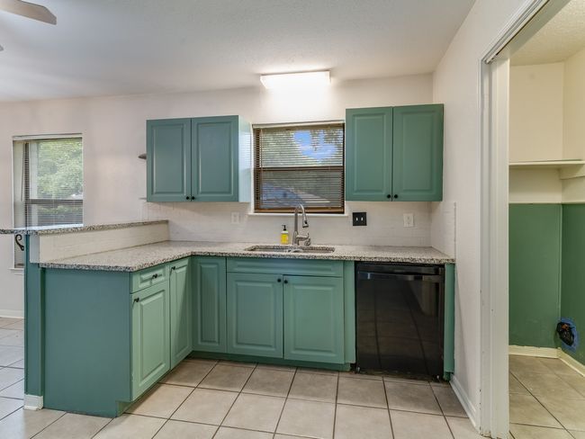 Kitchen featuring dishwasher, a peninsula, and light tile patterned flooring | Image 10