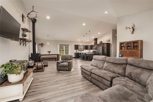 Great room openness encompassing living, dining and kitchen with cathedral ceiling | Image 5