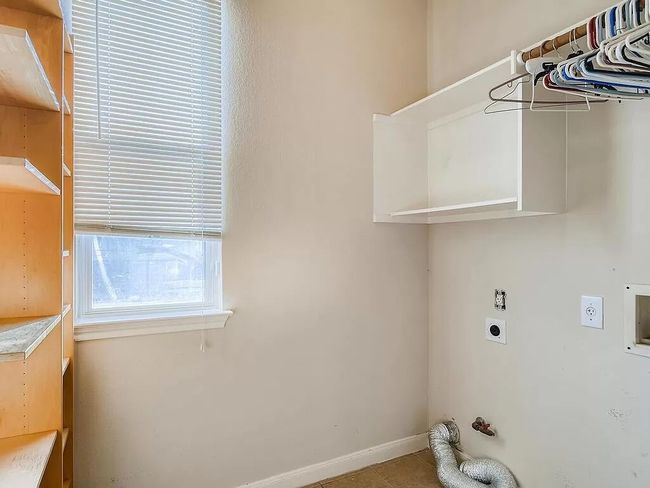 Washroom featuring hookup for an electric dryer, baseboards, and hookup for a washing machine | Image 23