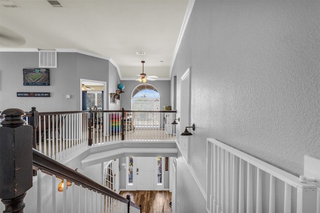 Stairs with ceiling fan, hardwood / wood-style flooring, and ornamental molding | Image 22