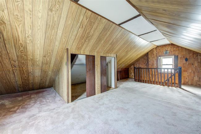 Additional living space featuring wood walls, lofted ceiling, and carpet flooring | Image 35