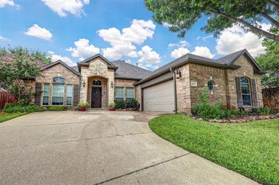 View of front of house featuring a garage and a front yard | Image 2