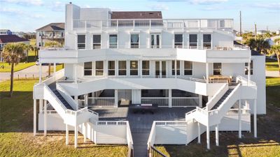 A view from the beach looking at the back of the home. | Image 1