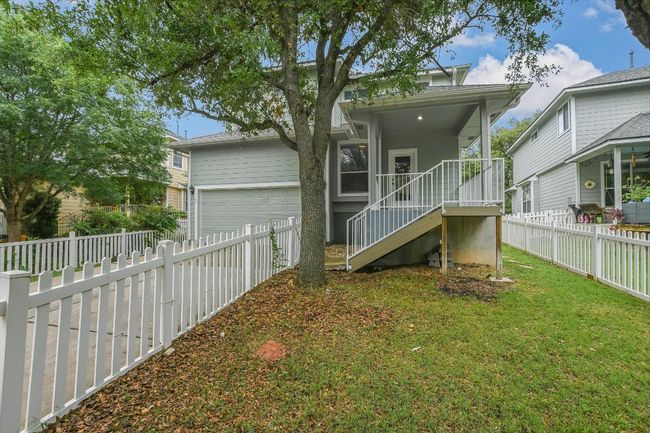 Rear view of house featuring a garage, a fenced backyard, and concrete driveway | Image 25
