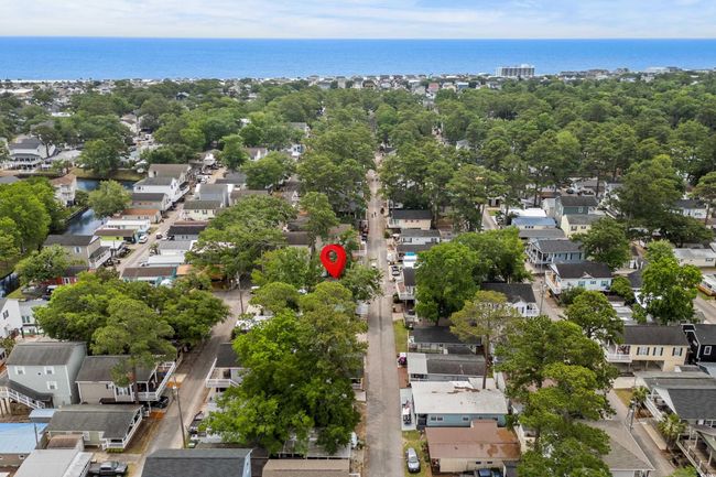 Aerial view of residential area featuring a large body of water | Image 24