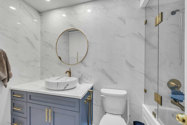 Full bathroom with vanity, tile walls, and bathing tub / shower combination | Image 20