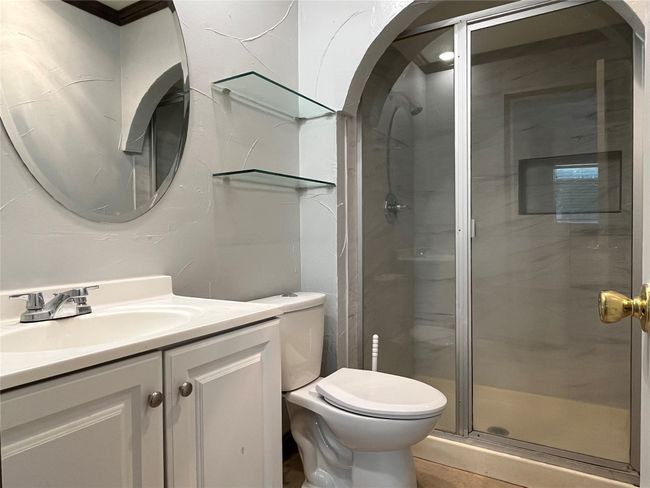 Full bathroom featuring toilet, vanity, and a shower stall | Image 17