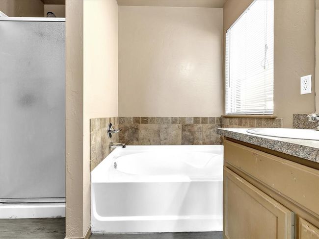 Full bathroom with a garden tub, a shower stall, vanity, and plenty of natural light | Image 11