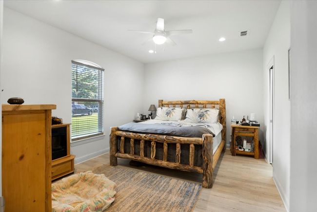 Bedroom featuring recessed lighting, light wood-style floors, ceiling fan, visible vents, and baseboards | Image 15