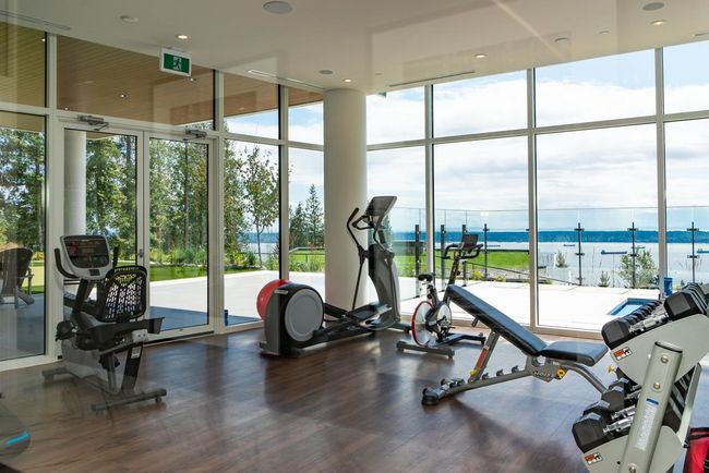 Gym with a water view, expansive windows, and wood finished floors | Image 35