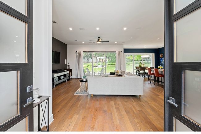 Living area with light wood-style flooring, recessed lighting, and a ceiling fan | Image 7