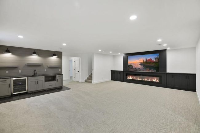 Mix your favorite cocktail, serve beer or wine to friends while watching game on big screen! Lower level is build for entertaining. Pictures of previously built house. | Image 24