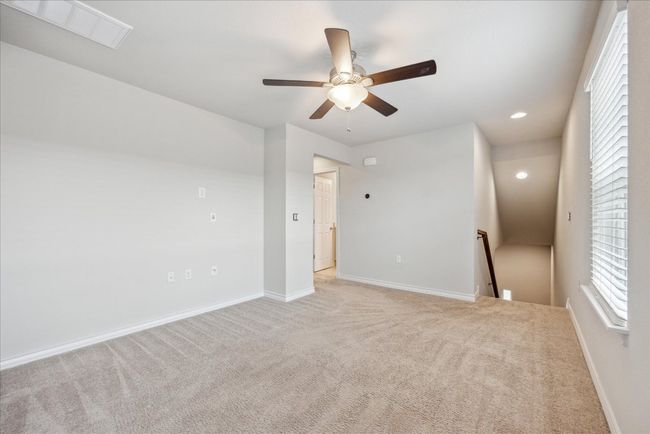 Empty room featuring light colored carpet, a ceiling fan, baseboards, recessed lighting, and visible vents | Image 14