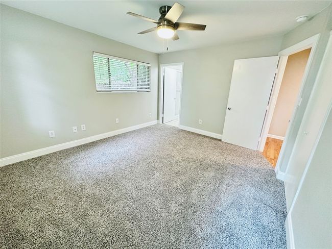 Unfurnished bedroom with carpet and ceiling fan | Image 12