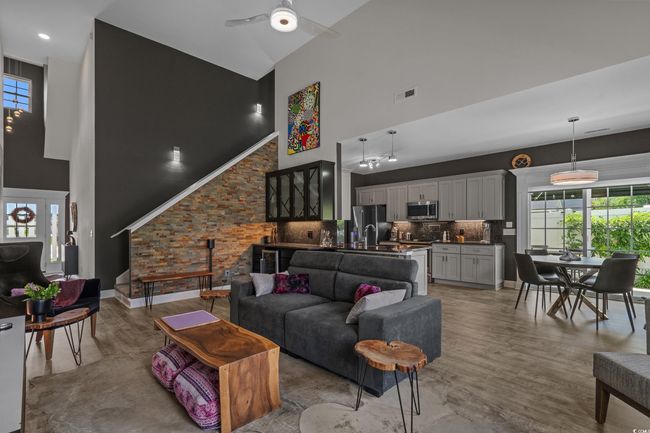 Living area featuring high vaulted ceiling, a ceiling fan, and light wood-style floors | Image 8