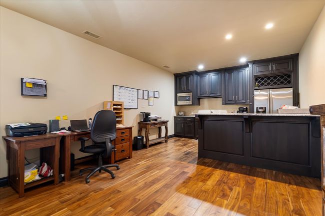 Office with wood finished floors and recessed lighting | Image 12