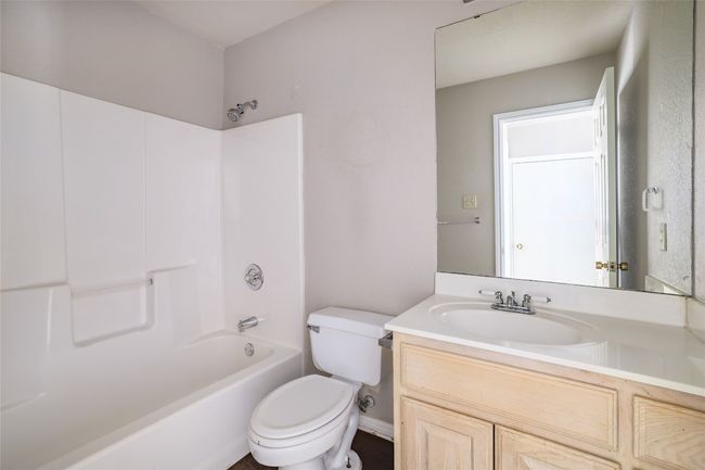 Full bathroom featuring toilet, vanity, and tub / shower combination | Image 11