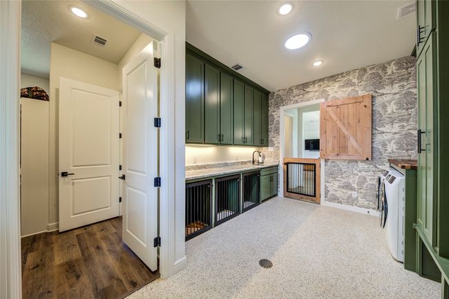 Mud room with washer and dryer, green cabinets, and a barn door | Image 20