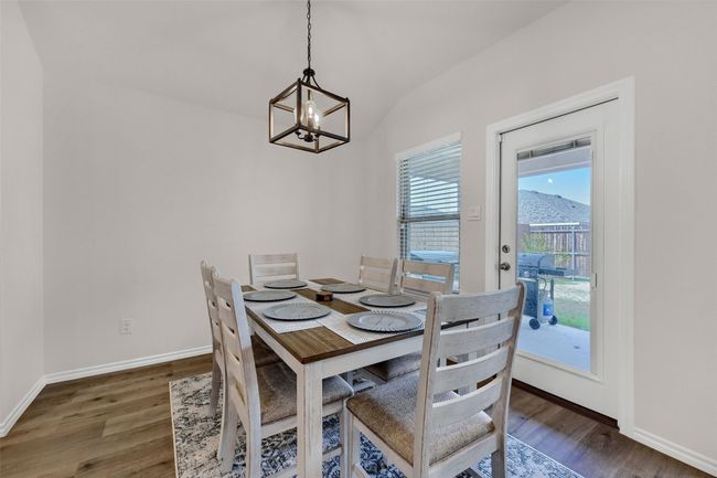 Dining room featuring a chandelier, wood finished floors, and vaulted ceiling | Image 10