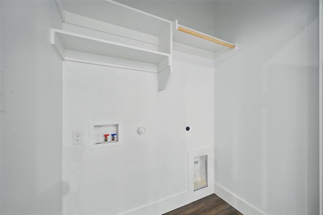 Laundry room with dark wood-style flooring, electric dryer hookup, gas dryer hookup, laundry area, and hookup for a washing machine | Image 15