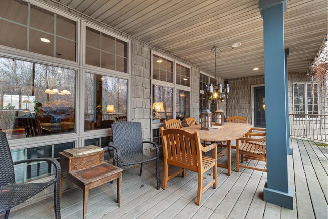 Full length covered patio with Trex-like flooring and view to backyard, and stairs to lower patio, spa and rod iron fenced area. Speakers connected to whole house audio. | Image 13