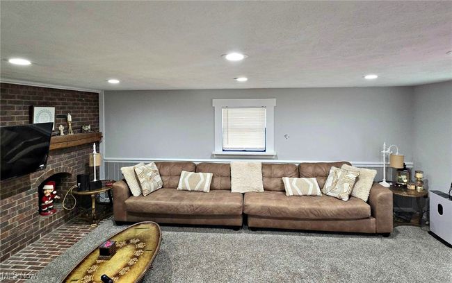 Living room with recessed lighting, a textured ceiling, and a fireplace | Image 27