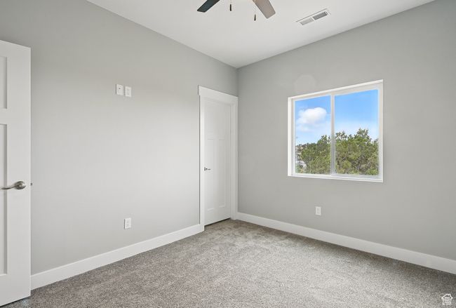Empty room with ceiling fan, carpet, and baseboards | Image 40