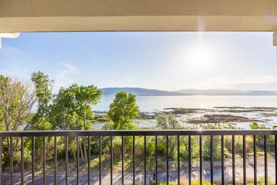 Balcony featuring a water and mountain view | Image 2