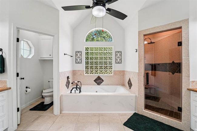 Primary bathroom features 2 vanity areas, a jetted soaking tub, and walk-in shower. | Image 21