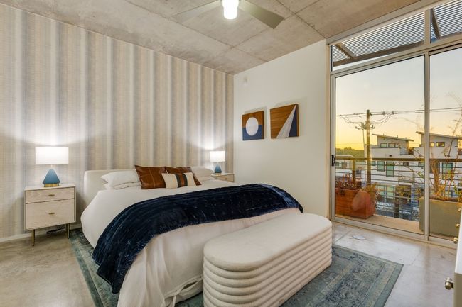 Bedroom with ceiling fan, concrete floors, and access to outside | Image 25