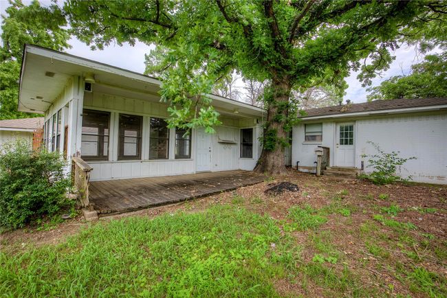 Rear view of house with entry steps and board and batten siding | Image 33