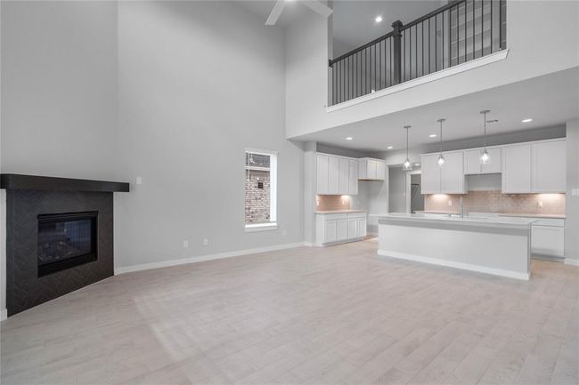 Another view of the spacious family room looking to the kitchen and second floor! | Image 9