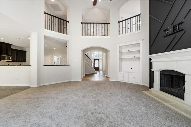 View from main living room leading into grand entryway. Notice the double height ceilings throughout creating a luxurious feel | Image 8
