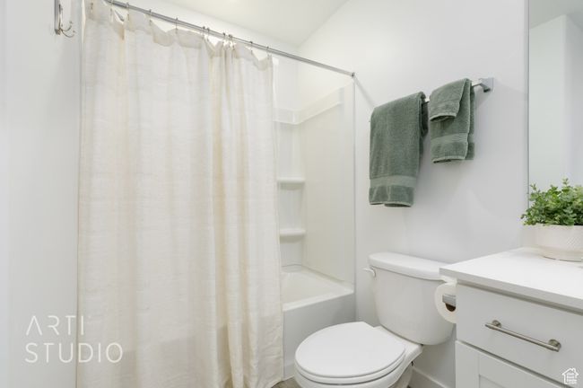 Full bathroom with shower / tub combo with curtain, toilet, and vanity | Image 30