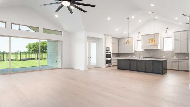 Kitchen with visible vents, ceiling fan, light countertops, high vaulted ceiling, and backsplash | Image 6
